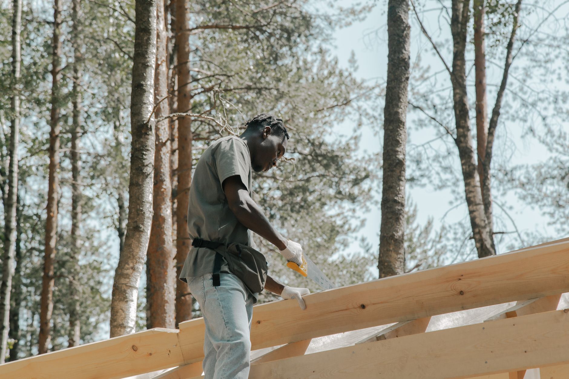 A close-up of high-quality, UV-resistant concrete roof tiles being carefully installed on an Enterprise home